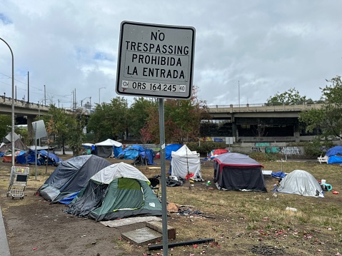 A no trespassing sign at a homeless encampment known as”the pit”