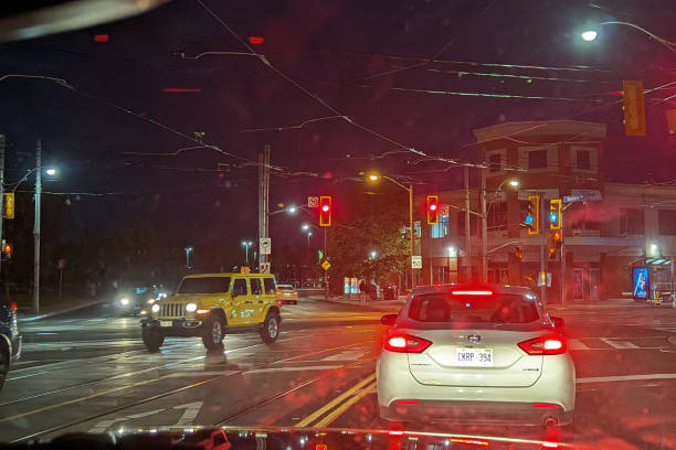Toronto, Canada - August 27, 2023: Traffic on Kingston Road and Eastern Avenue. Rainy night in The Beaches neighborhood.