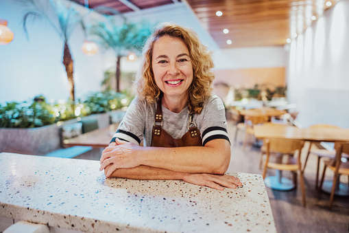Portrait of a mature waitress on coffee shop