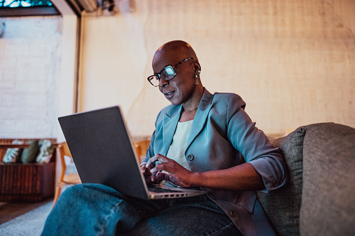 Businesswoman working using laptop at coffee shop