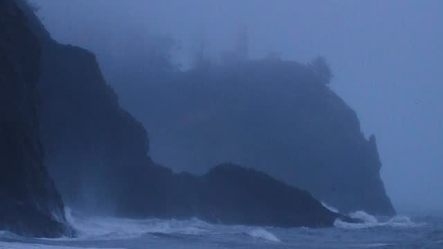 Lighthouse on a Fog Covered Cliff