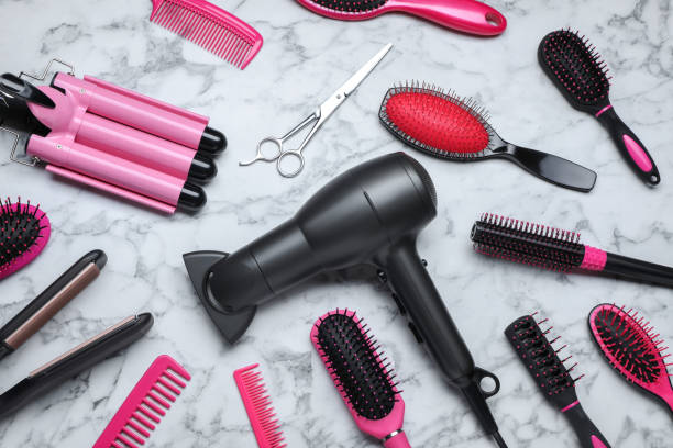 istock Flat lay composition of different professional hairdresser tools on white marble table 1719287714
