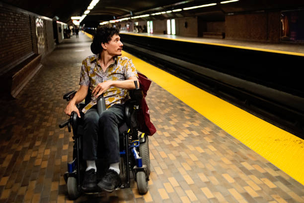 istock Young asian man using a wheelchair in a subway station. 1719309822