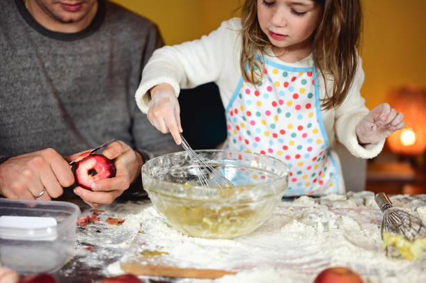 close up  of a making a cake together in a kitchen.