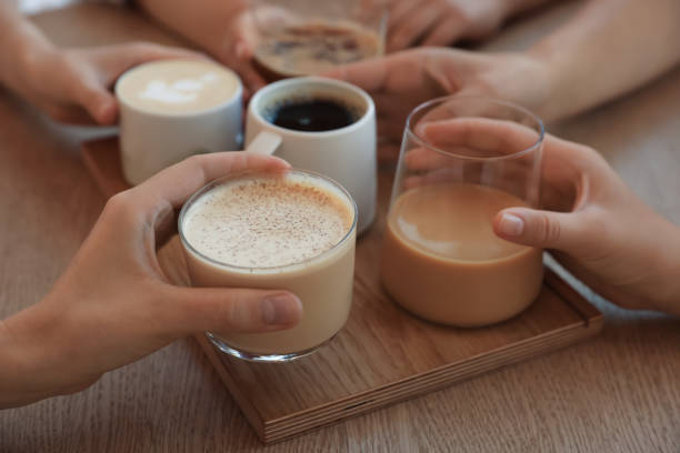 istock Friends drinking coffee at wooden table in cafe, closeup 1719365912