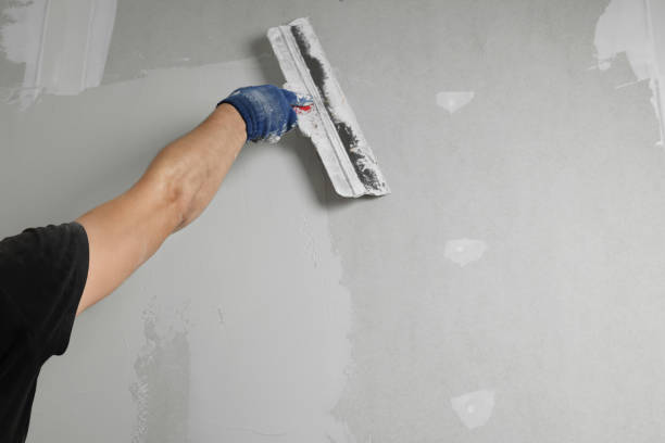 istock Professional worker plastering wall with putty knife, closeup 1719367008