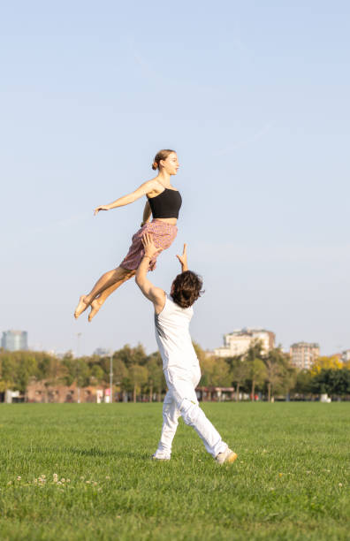 istock Two young athletes are jumping exercise in nature. 1719400401