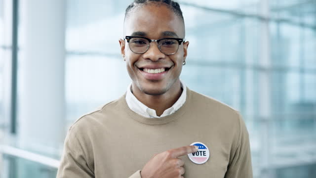 Face, vote and a black man pointing to a badge in support of freedom, democracy or choice in politics. Portrait, smile and proud of his choice, decision or selection of political party in an election