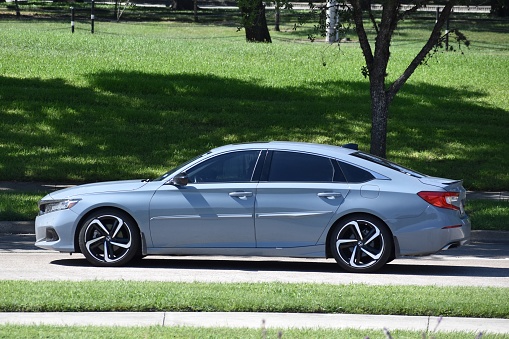 Houston, TX USA 10-1-2023 - A new baby blue Honda Accord hybrid sedan cruising near Herman Park in Houston