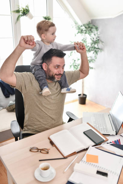 istock Freelancing Father Celebrating Work Success With Toddler Son 1719419561