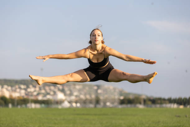 istock Young athlete woman is jumping on the grass. 1719446626