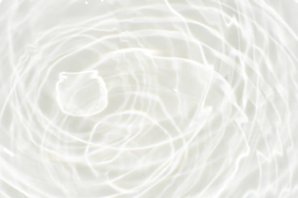 istock Defocus blurred transparent white colored clear calm water surface texture with splashes reflection. Trendy abstract nature background. Water waves in sunlight with copy space. Blue watercolor shine. 1719448125