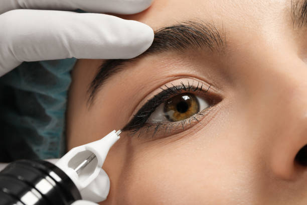 istock Young woman undergoing procedure of permanent eyeliner makeup, closeup 1719450257