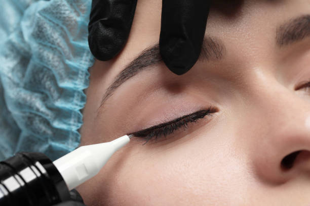istock Young woman undergoing procedure of permanent eye makeup, closeup 1719450286