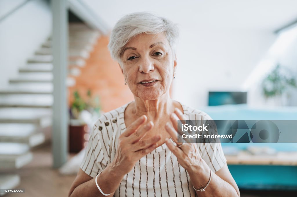 Portrait of an elderly woman talking on a video call at home Discussion Stock Photo