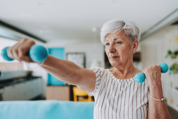 istock Portrait senior woman doing exercise at home 1719532751