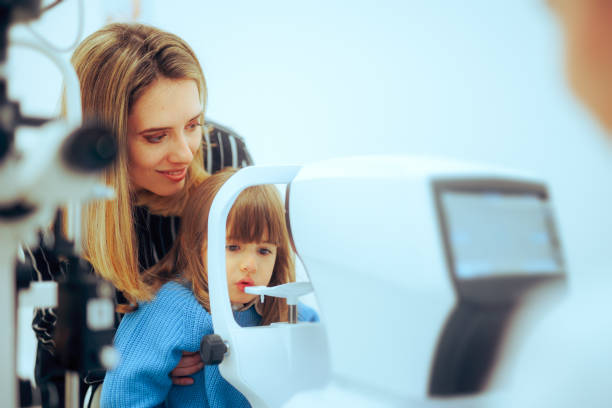 istock Mother Helping her Child During Eye Examination with a Slit Lamp Microscope 1719534823