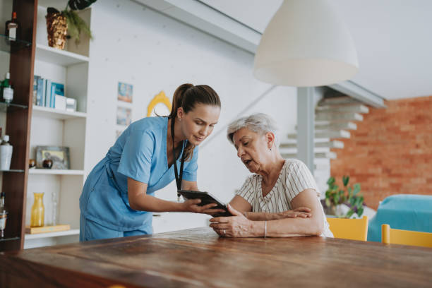 istock Home care healthcare professional using digital tablet 1719538018