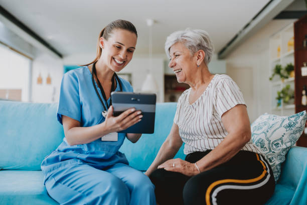 istock Home care healthcare professional using digital tablet 1719538594