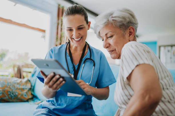 istock Home care healthcare professional using digital tablet 1719538625