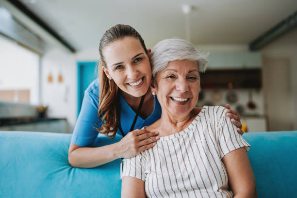 Home care healthcare professional hugging senior patient Home care healthcare professional hugging senior patient home care stock pictures, royalty-free photos & images