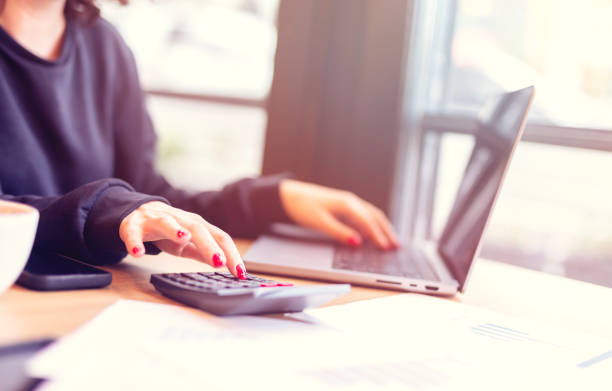 istock calculation concept, old hands counting finances on a home calculator 1719626450