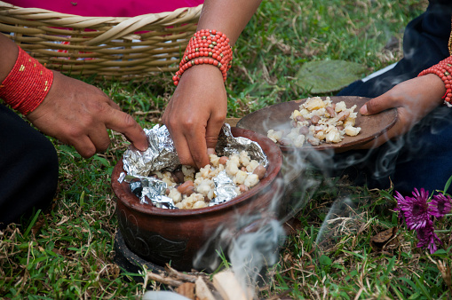 Ancestral Flavors: Indigenous Handcrafting a Meal in the Amazon Jungle. High quality photo