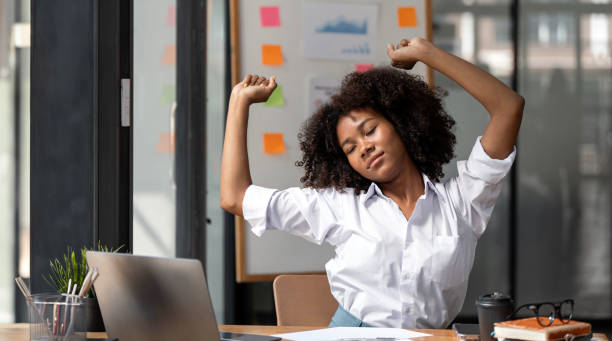 istock Relaxed african american woman resting after computer work in office hands over her head, sitting at office desk. 1719650838