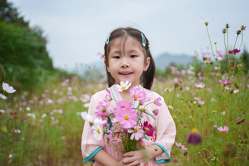 Children holding wildflowers