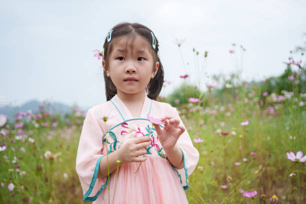 istock Children playing among flowers 1719660397