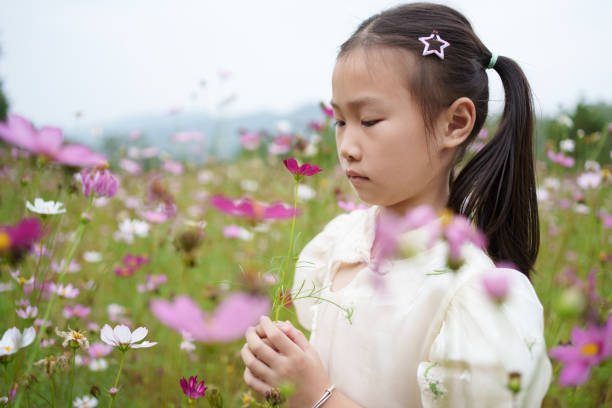 istock children admiring flowers 1719664211