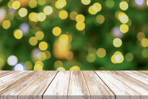 istock Empty wood table top with blur Christmas tree with bokeh light background 1719690279