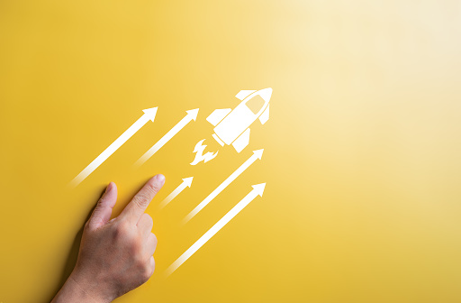 Start up idea, Starting new project concept. Hand pointing with a rocket launch and arrow icons. Business strategy for goal target success. Planning development leadership and customer target group.
