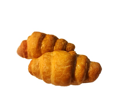 Two croissants laying on a white background