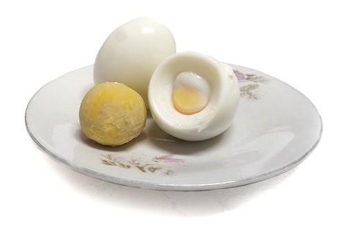 Three boiled eggs on a white plate