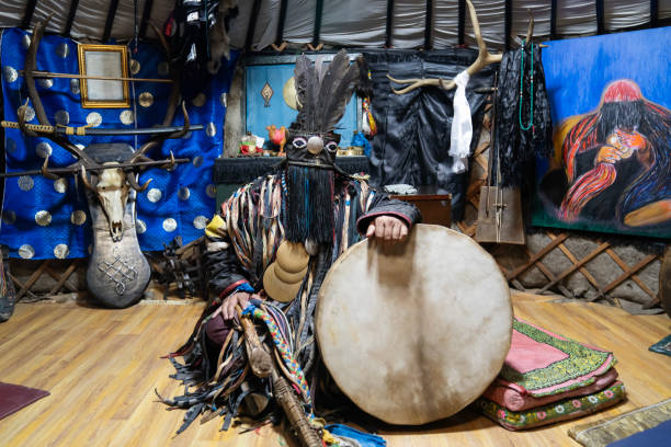 Ulaanbaatar, Mongolia - October 3, 2023: A shaman sits at his shrine inside a ger (yurt).