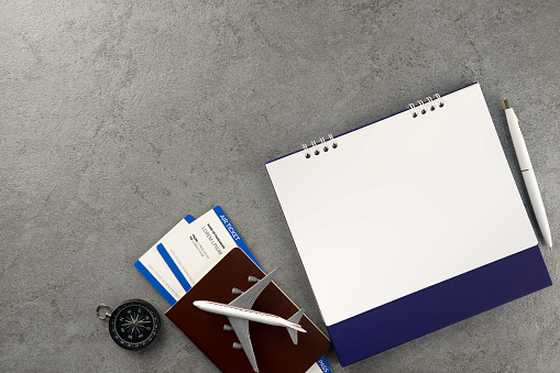 Passport with boarding pass and calendar on stone texture background. Tourism and travel concept. Top view. Flat lay.