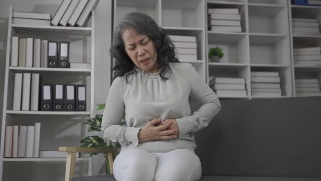 A woman with severe stomach pain caused by a patient suffering from food poisoning and a bacterial infection. Repository for diseases of the gastrointestinal tract,