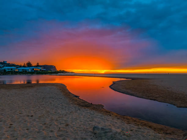 istock Sunrise at the seaside lagoon with cloud cover 1719819201