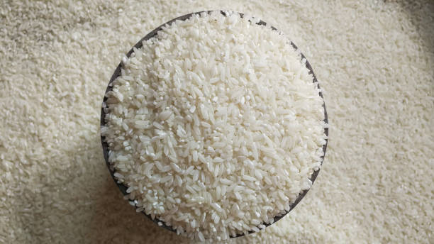 close up of rice in the container and some spilled around it