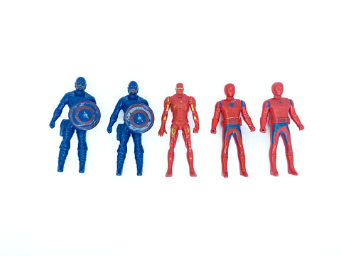 photo of an old Avengers superhero toy, on a white background, photographed in flatlay style