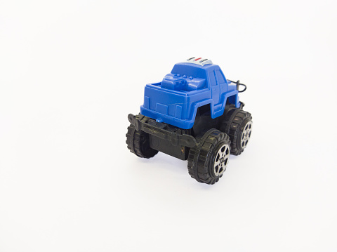 Blue toy car facing backwards on a white background