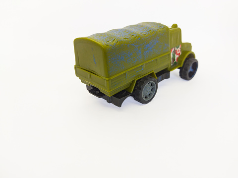 object photo of an army green toy soldier truck from behind on a white background