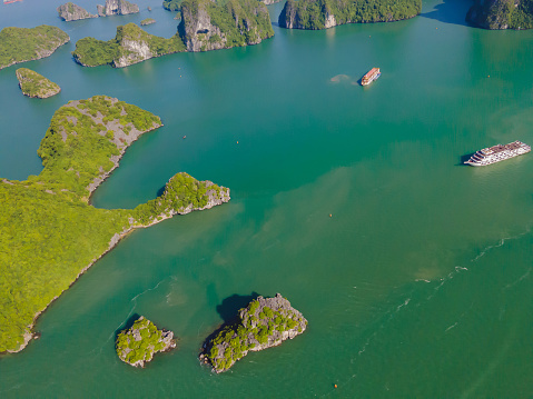 Aerial view panorama of floating fishing village and rock island, Halong Bay, Vietnam, Southeast Asia. UNESCO World Heritage Site. Junk boat cruise to Ha Long Bay. Popular landmark of Vietnam.