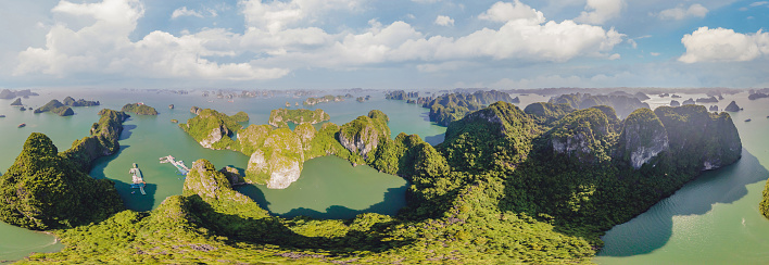 Aerial view panorama of floating fishing village and rock island, Halong Bay, Vietnam, Southeast Asia. UNESCO World Heritage Site. Junk boat cruise to Ha Long Bay. Popular landmark of Vietnam.