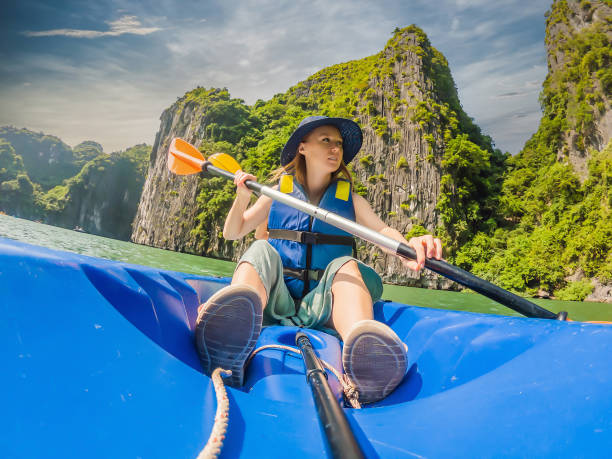 mom, dad and son travelers rowing on a kayak in halong bay. vietnam. travel to asia, happiness emotion, summer holiday concept. traveling with children concept. after covid 19. picturesque sea landscape. ha long bay, vietnam - 7678 imagens e fotografias de stock