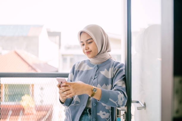 istock Beautiful Asian Woman walking While Using Smartphone. 1719850669