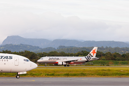 Gold Coast, Australia - 16 March 2022: JetstarAirbus A320 taxiing at Gold Coast Airport (OOL) in preparation for takeoff.