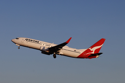 Townsville, Australia - 10 August 2022: Qantas Boeing 737-800 taking off at Townsville Airport, Queensland (TSV) in the early morning.