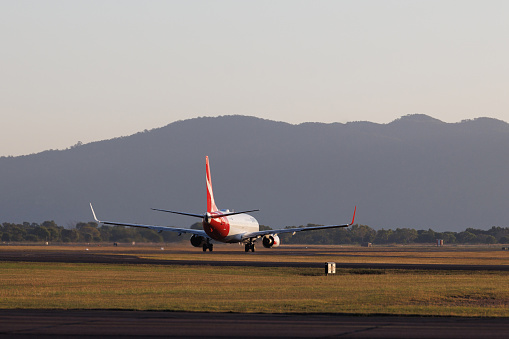 Townsville, Australia - 10 August 2022: Qantas Boeing 737-800 preparing for take off at Townsville Airport, Queensland (TSV) in the early morning.